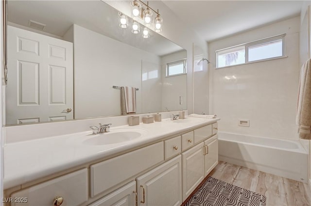10921 Calcedonian St, Las Vegas, NV 89141 - full bath with double vanity, wood finished floors, and shower / washtub combination