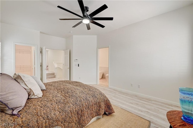 10921 Calcedonian St, Las Vegas, NV 89141 - bedroom with light wood-style floors, ensuite bath, a walk in closet, and a ceiling fan