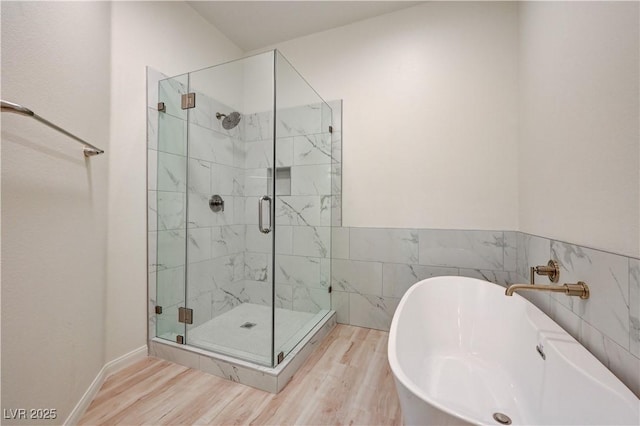 10921 Calcedonian St, Las Vegas, NV 89141 - bathroom featuring a shower stall, a soaking tub, and wood finished floors