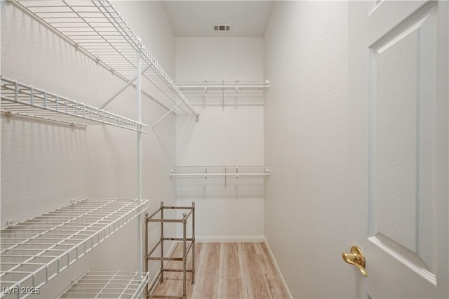 10921 Calcedonian St, Las Vegas, NV 89141 - walk in closet featuring wood finished floors