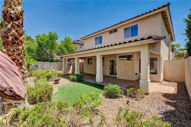10921 Calcedonian St, Las Vegas, NV 89141 - back of property with stucco siding, a fenced backyard, a patio, and a tile roof