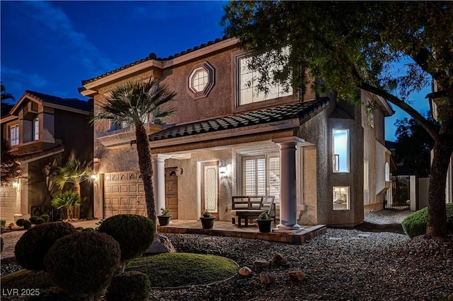 10921 Calcedonian St, Las Vegas, NV 89141 - view of front of property with a tiled roof, a garage, and stucco siding