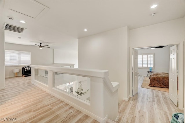 10921 Calcedonian St, Las Vegas, NV 89141 - hall with an upstairs landing, light wood finished floors, and recessed lighting