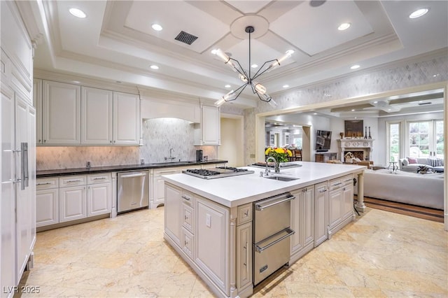 30 Augusta Canyon Way, Las Vegas, NV 89141 - kitchen with appliances with stainless steel finishes, a chandelier, backsplash, open floor plan, and ornamental molding