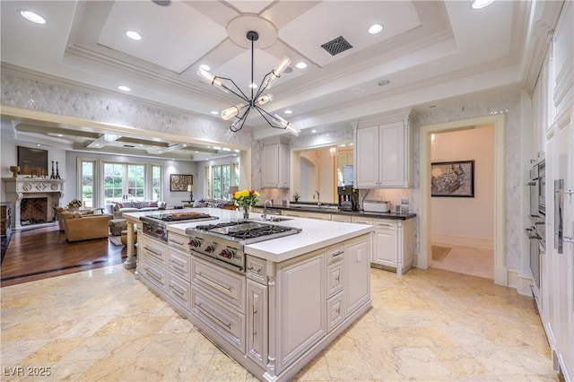 30 Augusta Canyon Way, Las Vegas, NV 89141 - kitchen with a chandelier, ornamental molding, open floor plan, stainless steel gas stovetop, and a fireplace
