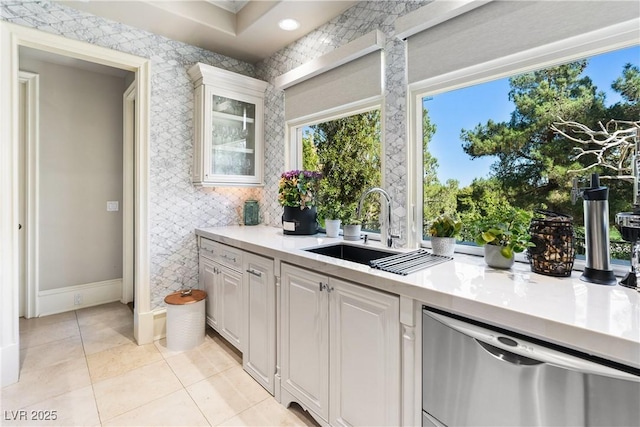 30 Augusta Canyon Way, Las Vegas, NV 89141 - kitchen featuring dishwasher, light countertops, glass insert cabinets, light tile patterned floors, and white cabinetry