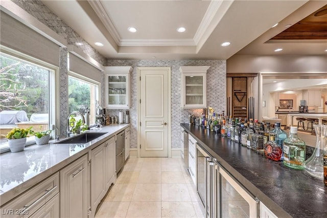 30 Augusta Canyon Way, Las Vegas, NV 89141 - kitchen featuring beverage cooler, a tray ceiling, glass insert cabinets, crown molding, and light tile patterned flooring