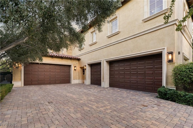 30 Augusta Canyon Way, Las Vegas, NV 89141 - view of front of home featuring stucco siding, decorative driveway, and a garage