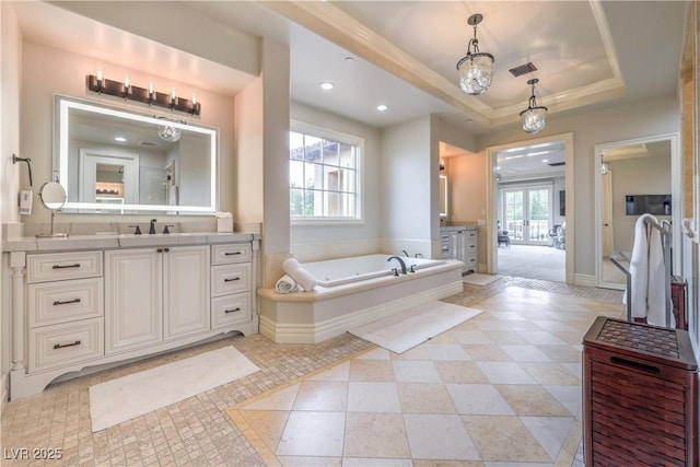 30 Augusta Canyon Way, Las Vegas, NV 89141 - bathroom with vanity, a bath, a tray ceiling, and recessed lighting