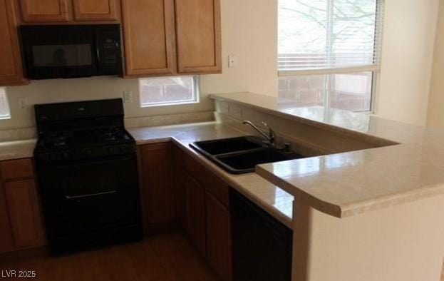 3711 Lodina Ct, Las Vegas, NV 89141 - kitchen featuring black appliances, a peninsula, plenty of natural light, and light countertops