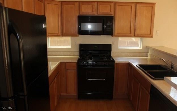 3711 Lodina Ct, Las Vegas, NV 89141 - kitchen featuring black appliances, brown cabinets, light countertops, and wood finished floors