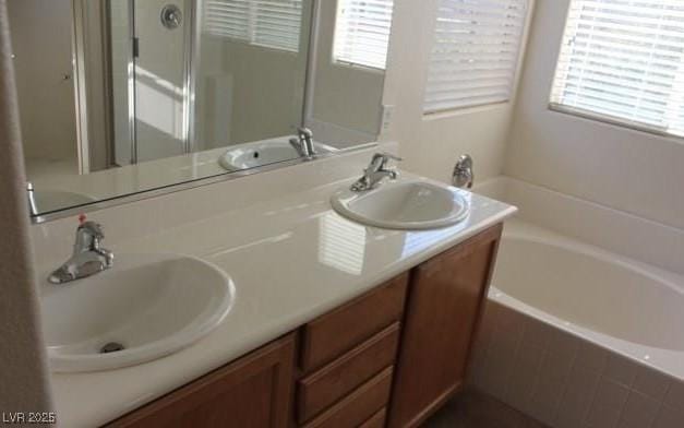 3711 Lodina Ct, Las Vegas, NV 89141 - full bath featuring plenty of natural light, a bath, double vanity, and a shower stall