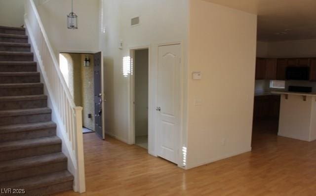 3711 Lodina Ct, Las Vegas, NV 89141 - stairway featuring wood finished floors and a towering ceiling