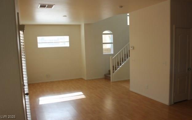 3711 Lodina Ct, Las Vegas, NV 89141 - spare room with plenty of natural light, stairs, and wood finished floors