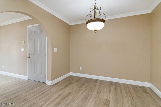 2451 N Rainbow Blvd Unit 1091, Las Vegas, NV 89108 - spare room featuring arched walkways, light wood-type flooring, and crown molding