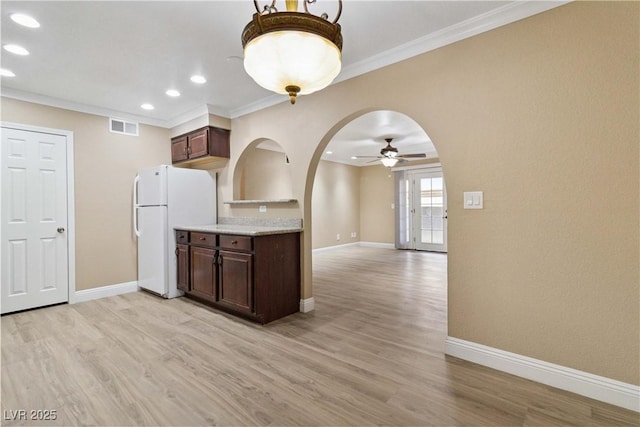 2451 N Rainbow Blvd Unit 1091, Las Vegas, NV 89108 - kitchen with freestanding refrigerator, ceiling fan, dark brown cabinetry, recessed lighting, and light wood-style flooring