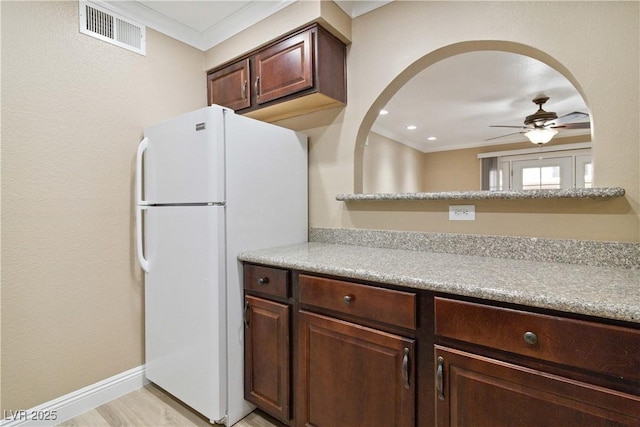 2451 N Rainbow Blvd Unit 1091, Las Vegas, NV 89108 - kitchen featuring freestanding refrigerator, ceiling fan, ornamental molding, light countertops, and arched walkways