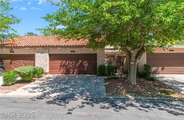 2486 Sabado St, Las Vegas, NV 89121 - view of front of property with a garage, concrete driveway, stucco siding, and a tiled roof