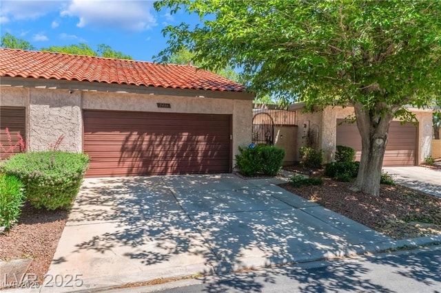2486 Sabado St, Las Vegas, NV 89121 - mediterranean / spanish-style home with stucco siding, a garage, concrete driveway, and a tiled roof