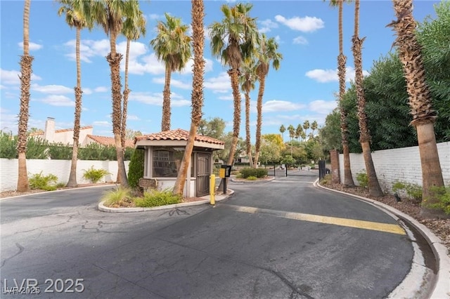 2486 Sabado St, Las Vegas, NV 89121 - view of asphalt road with curbs, a gated entry, and a gate
