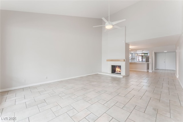 2486 Sabado St, Las Vegas, NV 89121 - unfurnished living room with a brick fireplace, a towering ceiling, and a ceiling fan