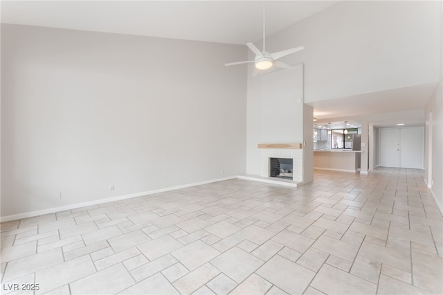 2486 Sabado St, Las Vegas, NV 89121 - unfurnished living room with a fireplace, a towering ceiling, and ceiling fan