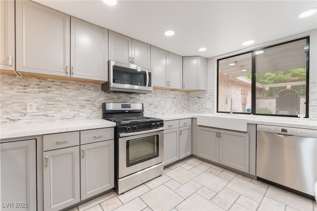 2486 Sabado St, Las Vegas, NV 89121 - kitchen featuring appliances with stainless steel finishes, gray cabinets, light countertops, decorative backsplash, and recessed lighting