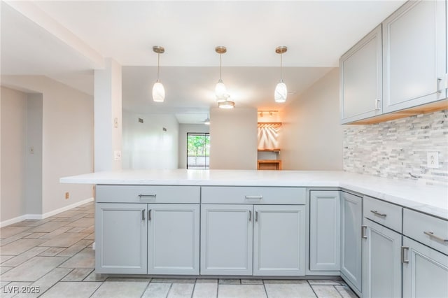 2486 Sabado St, Las Vegas, NV 89121 - kitchen featuring a peninsula, backsplash, decorative light fixtures, and gray cabinets