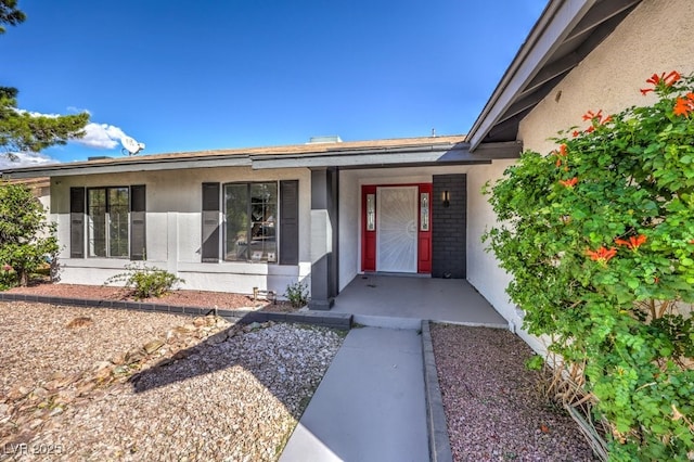 3425 Irv Marcus Dr, Las Vegas, NV 89108 - doorway to property with stucco siding and a porch