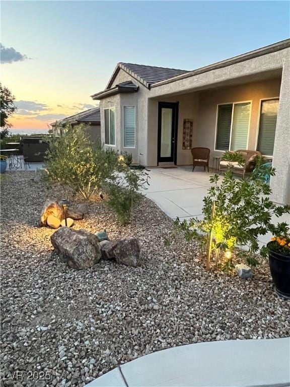 2257 Turner Falls St, Henderson, NV 89044 - view of front of house with stucco siding, a patio area, and a tile roof