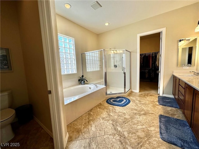 2257 Turner Falls St, Henderson, NV 89044 - full bathroom with vanity, a shower stall, a garden tub, and a walk in closet