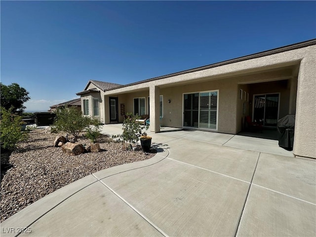 2257 Turner Falls St, Henderson, NV 89044 - rear view of house with stucco siding and a patio area