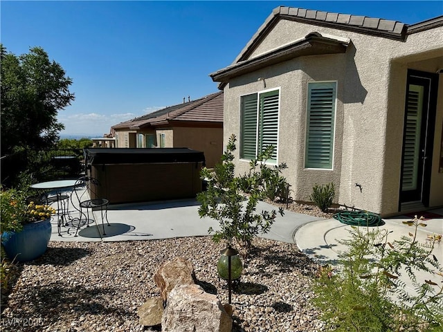 2257 Turner Falls St, Henderson, NV 89044 - view of side of home featuring a hot tub, a patio area, and stucco siding
