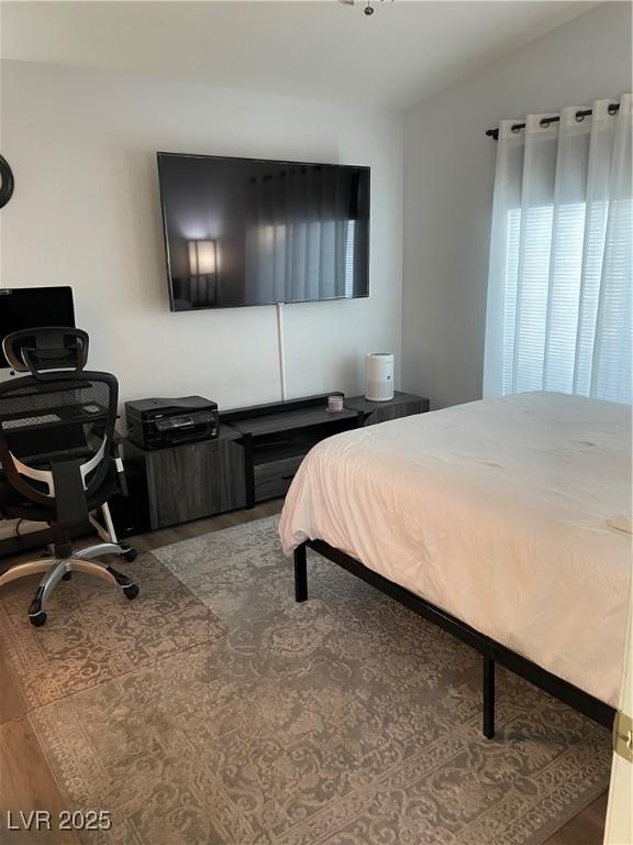 3521 Hazelnut Pine Pl Unit 1, North Las Vegas, NV 89084 - bedroom with a desk, wood finished floors, and vaulted ceiling