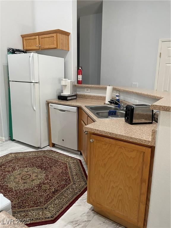 3521 Hazelnut Pine Pl Unit 1, North Las Vegas, NV 89084 - kitchen with white appliances, light marble finish floors, and a peninsula