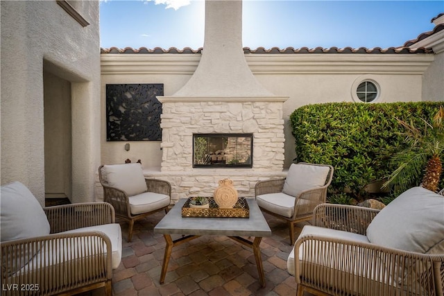 11830 Kingsbarns Ct, Las Vegas, NV 89141 - view of patio / terrace featuring an outdoor living space with a fireplace