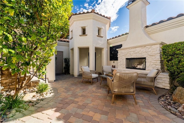 11830 Kingsbarns Ct, Las Vegas, NV 89141 - view of patio / terrace with an outdoor living space with a fireplace