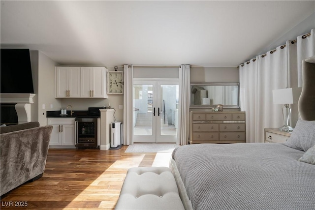 11830 Kingsbarns Ct, Las Vegas, NV 89141 - bedroom with beverage cooler, access to exterior, french doors, dark wood finished floors, and wet bar
