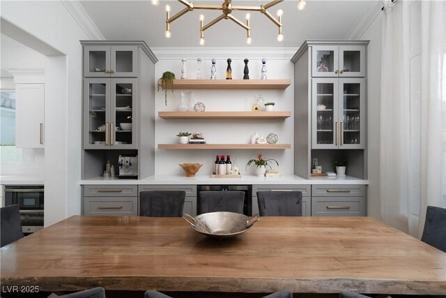 11830 Kingsbarns Ct, Las Vegas, NV 89141 - indoor wet bar featuring crown molding and a chandelier