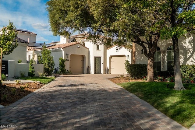 11830 Kingsbarns Ct, Las Vegas, NV 89141 - mediterranean / spanish-style house with an attached garage, stucco siding, decorative driveway, and a tiled roof
