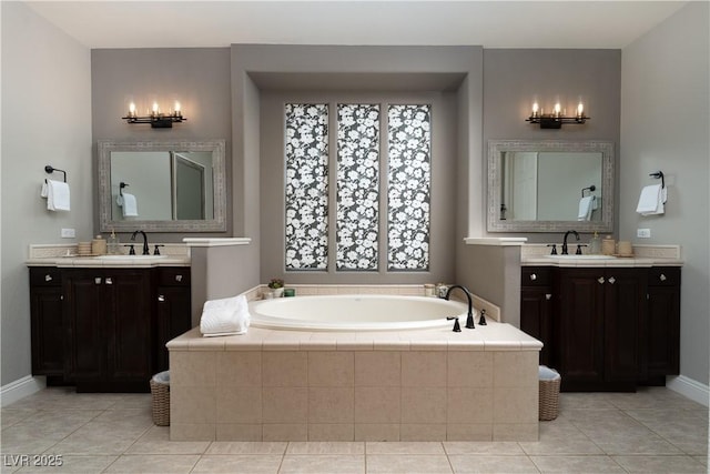 11830 Kingsbarns Ct, Las Vegas, NV 89141 - full bathroom featuring a bath, two vanities, and tile patterned floors