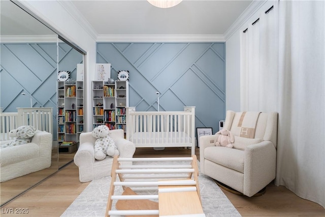 11830 Kingsbarns Ct, Las Vegas, NV 89141 - bedroom with a decorative wall, ornamental molding, wood finished floors, and a nursery area