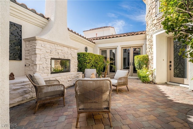 11830 Kingsbarns Ct, Las Vegas, NV 89141 - view of patio with an outdoor living space with a fireplace