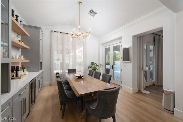 11830 Kingsbarns Ct, Las Vegas, NV 89141 - dining area featuring a chandelier, french doors, crown molding, light wood-type flooring, and beverage cooler