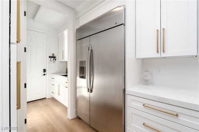 11830 Kingsbarns Ct, Las Vegas, NV 89141 - kitchen featuring stainless steel built in fridge, light wood-style flooring, white cabinets, and light stone counters