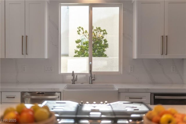 11830 Kingsbarns Ct, Las Vegas, NV 89141 - kitchen with light countertops, dishwasher, and tasteful backsplash