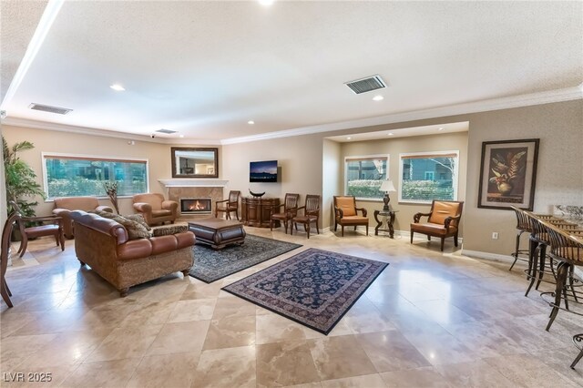 5250 S Rainbow Blvd Unit 1167, Las Vegas, NV 89118 - living room featuring ornamental molding, healthy amount of natural light, a glass covered fireplace, and recessed lighting