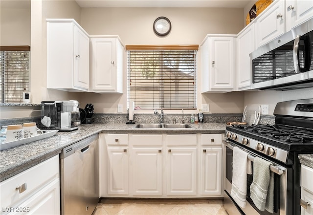 5250 S Rainbow Blvd Unit 1167, Las Vegas, NV 89118 - kitchen featuring stainless steel appliances, white cabinets, light tile patterned flooring, and plenty of natural light