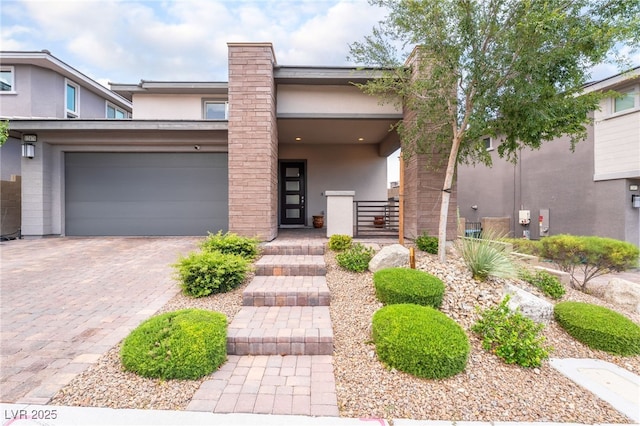 12478 Dolan Point St, Las Vegas, NV 89138 - view of front of property featuring stucco siding, decorative driveway, an attached garage, and a gate