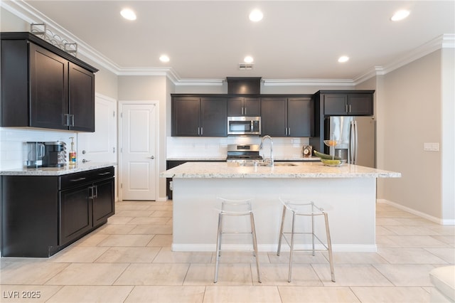 12478 Dolan Point St, Las Vegas, NV 89138 - kitchen with stainless steel appliances, decorative backsplash, light tile patterned flooring, light stone counters, and recessed lighting
